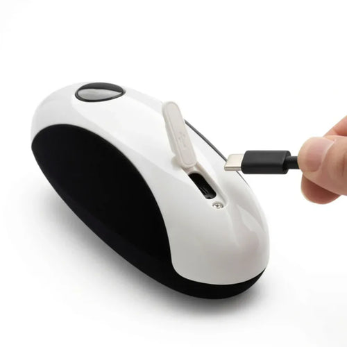 Hand holding USB-C cable near a white and black rechargeable adaptive aid device.