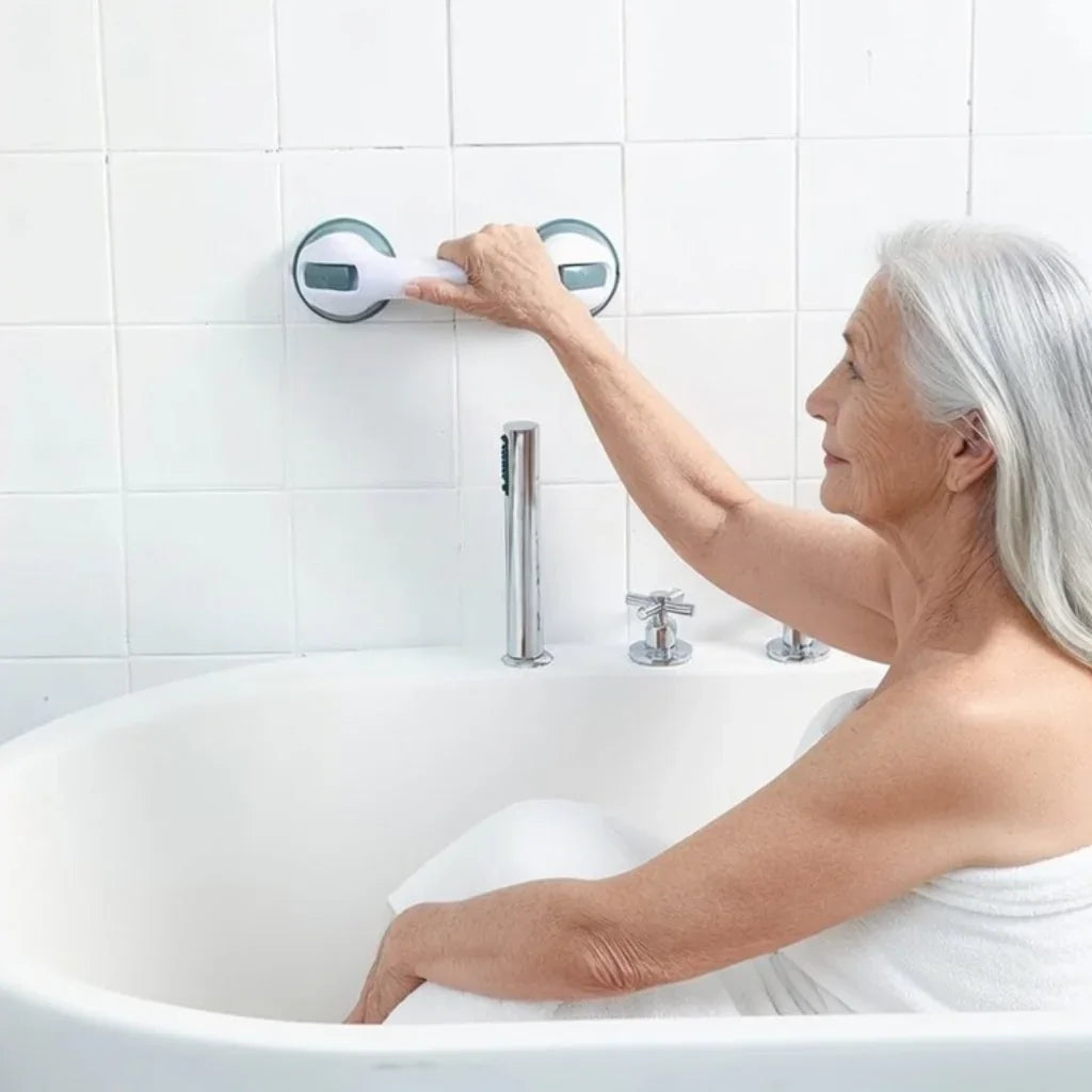 Senior woman using suction grab bar for safe support in a white bathroom tub.