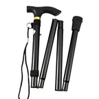 Black folding walking cane with ergonomic handle and wrist strap, adaptive mobility aid