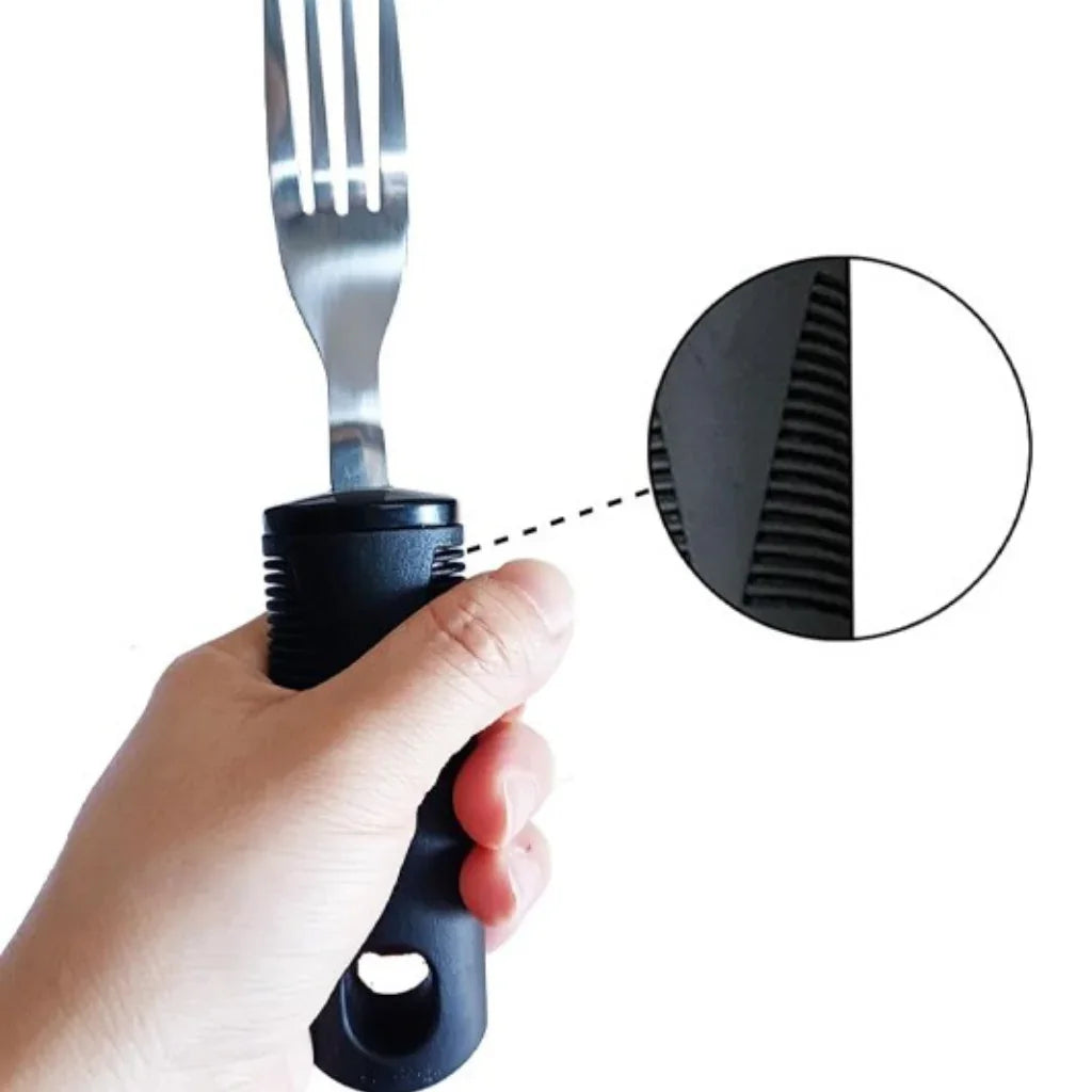 Hand holding an ergonomic adaptive fork with textured grip for arthritis or limited mobility