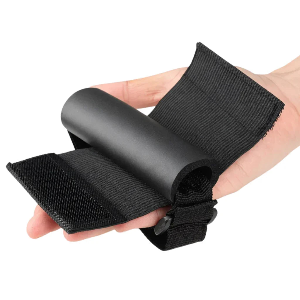Hand holding black adaptive grip aid strap for limited mobility or arthritic hands