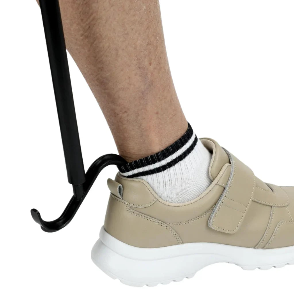 Adaptive shoe horn assisting with beige sneaker removal for mobility support