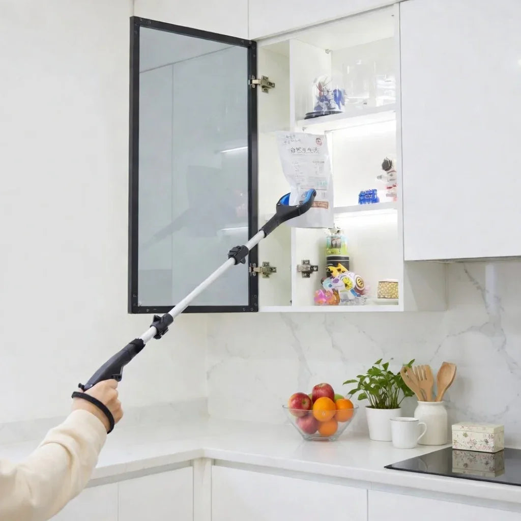 Person using a long reach grabber tool to retrieve an item from a high kitchen cabinet