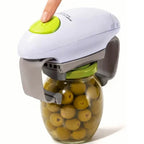 Electric jar opener for arthritis shown opening a glass jar of green olives