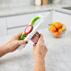 Person using a jar opener tool on a jar in a modern kitchen, adaptive aid for arthritis