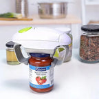Electric jar opener on a tomato pasta sauce jar in a kitchen, adaptive aid for easy opening.