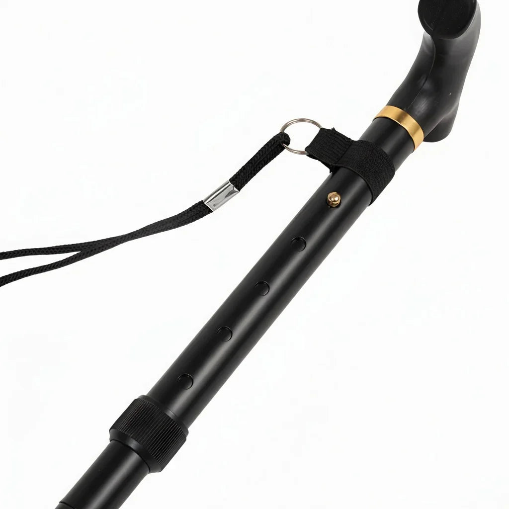 Black adjustable walking cane with ergonomic handle and wrist strap on white background