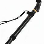 Black adjustable walking cane with ergonomic handle and wrist strap on white background