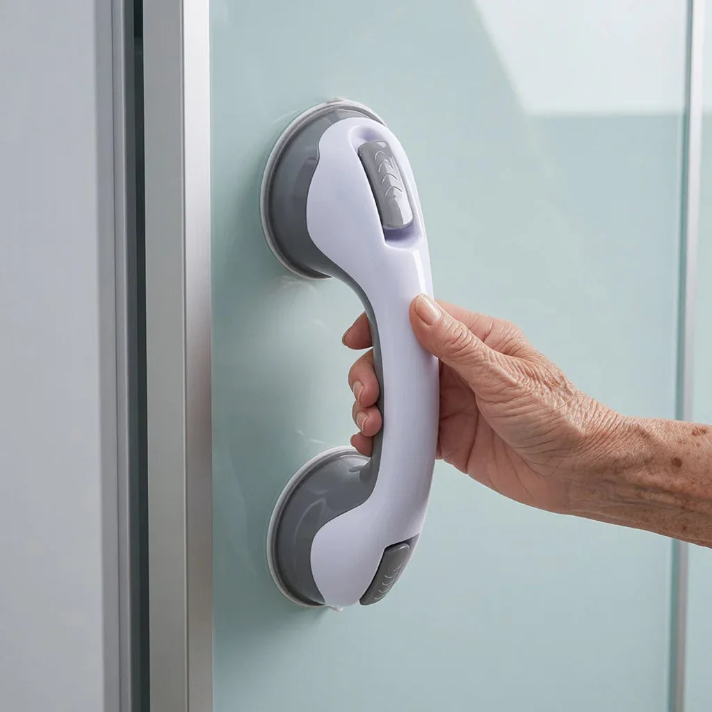 Hand gripping a suction shower grab bar on a smooth glass surface for bathroom safety