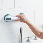 Elderly hand gripping a bathroom suction grab bar for safety and support on tiled wall