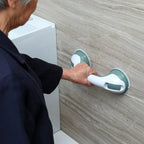 Senior using suction grab bar on bathroom wall for support and safety