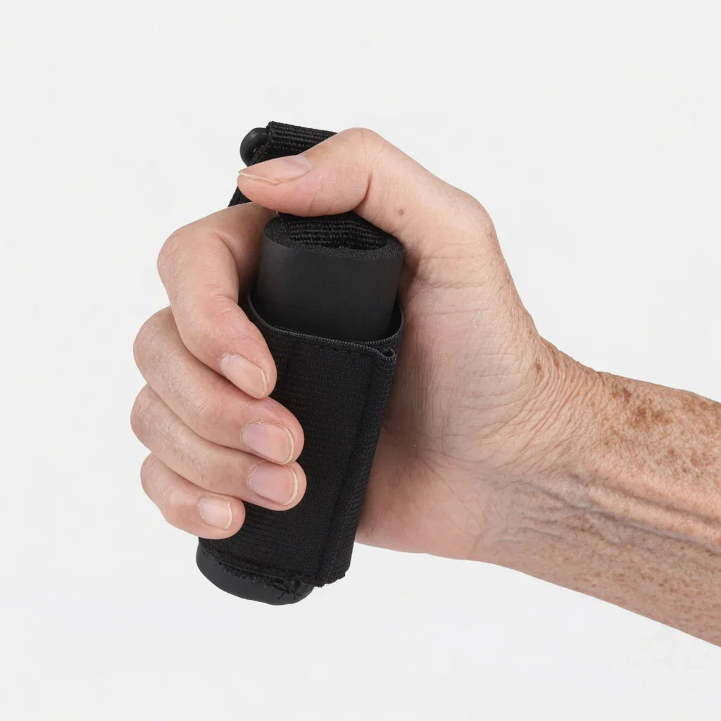 Hand holding ergonomic black foam grip aid for arthritis and limited mobility