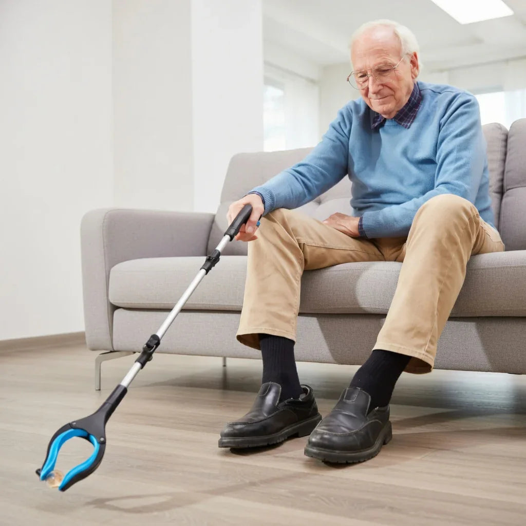 Elderly man using a long-handled grabber reacher tool to pick up item from floor in living room