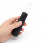 Hand holding a black adaptive button hook for arthritis and limited mobility