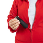 Hand using a black adaptive zipper pull aid on a red jacket, ideal for limited mobility