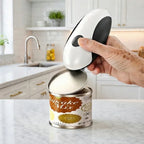 Person using an electric can opener to open a can of cupcake mix in a modern kitchen